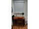 Office area highlighting a vintage wooden desk, chair, natural light, and a minimalistic workspace at 4212 Logan Dr, Loganville, GA 30052