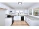 Bright kitchen featuring white cabinets and modern appliances at 4212 Logan Dr, Loganville, GA 30052