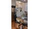 Well-lit kitchenette, stainless steel fridge, eat-in table, and white cabinets at 4212 Logan Dr, Loganville, GA 30052