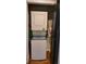 A laundry area showcasing a stacked washer and dryer unit and convenient storage solutions at 4212 Logan Dr, Loganville, GA 30052