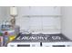 Functional laundry room featuring modern washer and dryer with shelving at 4212 Logan Dr, Loganville, GA 30052