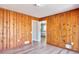 Living room with wood paneling, and access to other rooms at 4212 Logan Dr, Loganville, GA 30052