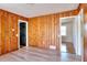 Living room with wood paneling, and access to other rooms at 4212 Logan Dr, Loganville, GA 30052