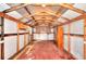 Interior of a shed with wooden beams, storage cabinets and wood floor at 4212 Logan Dr, Loganville, GA 30052
