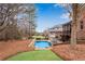 Backyard view of beautiful in-ground pool with spa, patios, and screened porch at 4850 Kentwood Dr, Marietta, GA 30068