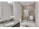 Bathroom featuring granite countertops, a modern vanity, and a shower/tub combination with a glass door at 4850 Kentwood Dr, Marietta, GA 30068