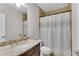 Bathroom featuring a granite countertop, large mirror, and shower with an elegant shower curtain at 4850 Kentwood Dr, Marietta, GA 30068