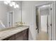 Well-lit bathroom featuring granite countertops, modern fixtures, and a view into an adjacent room with a bathtub/shower combination at 4850 Kentwood Dr, Marietta, GA 30068