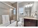 Well-lit bathroom featuring a granite-topped vanity, ceramic tiled shower with glass doors, and neutral color palette at 4850 Kentwood Dr, Marietta, GA 30068