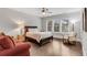 Bright and airy bedroom featuring hardwood floors, a ceiling fan, large windows, and comfortable seating at 4850 Kentwood Dr, Marietta, GA 30068