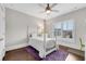 Bright bedroom featuring hardwood floors, white-painted walls, and a window with shutter-style shades at 4850 Kentwood Dr, Marietta, GA 30068