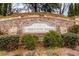Entrance to Ashton Woods' Cobblestone Manor community, marked by a stone sign and lush landscaping at 4850 Kentwood Dr, Marietta, GA 30068