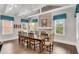Elegant dining room featuring a long wooden table, multiple windows, and ample seating at 4850 Kentwood Dr, Marietta, GA 30068