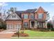 Elegant brick home with a well-manicured lawn and a two-car garage at 4850 Kentwood Dr, Marietta, GA 30068