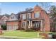 Beautiful brick home featuring a cozy front porch and landscaped yard at 4850 Kentwood Dr, Marietta, GA 30068