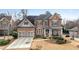 Stunning brick home with a manicured lawn, charming front porch, and a two-car garage at 4850 Kentwood Dr, Marietta, GA 30068