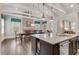 Bright kitchen island, stainless appliances, custom cabinets, dining area, and modern lighting at 4850 Kentwood Dr, Marietta, GA 30068