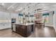 Bright kitchen with island, stainless appliances, custom cabinets, dining area, and modern lighting at 4850 Kentwood Dr, Marietta, GA 30068