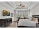 The main bedroom with tray ceilings, a sitting area and TV; hardwood flooring adds warmth at 4850 Kentwood Dr, Marietta, GA 30068