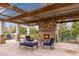 Outdoor fireplace with stone surround, covered patio, and comfortable seating area, perfect for entertaining at 4850 Kentwood Dr, Marietta, GA 30068