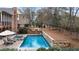 Inviting backyard oasis with a swimming pool, hot tub, lounge chairs, and lush greenery at 4850 Kentwood Dr, Marietta, GA 30068