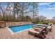Gorgeous in-ground pool with a tanning ledge, spa, and ample patio space at 4850 Kentwood Dr, Marietta, GA 30068