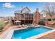A refreshing swimming pool and hot tub surrounded by a patio and lush landscaping at 4850 Kentwood Dr, Marietta, GA 30068