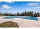 Large community pool with a green cover, surrounded by concrete and decorative pergola feature at 4850 Kentwood Dr, Marietta, GA 30068