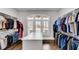 The walk-in closet features custom shelving and hanging racks, and hardwood floors for organized storage at 4850 Kentwood Dr, Marietta, GA 30068