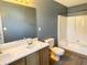 Bathroom with double sinks, wood cabinets and shower-tub combination at 2199 Ramblewood Cir, Decatur, GA 30035