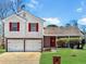 Charming two-story home features a two-car garage and manicured lawn at 2199 Ramblewood Cir, Decatur, GA 30035