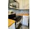 Butcher block countertops and mosaic backsplash add charm to this kitchen at 2199 Ramblewood Cir, Decatur, GA 30035
