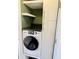 Functional laundry area with a front load washer, storage, and modern countertop at 2199 Ramblewood Cir, Decatur, GA 30035