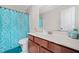 Well-lit bathroom with a sleek vanity, modern mirror, and shower-tub combination featuring a stylish patterned curtain at 2283 Shady Maple Ln, Loganville, GA 30052