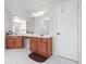 Primary bathroom with double vanity, large mirror, and white tile flooring at 2283 Shady Maple Ln, Loganville, GA 30052