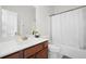 Bathroom with wood vanity, shower-tub combo, and neutral decor at 2283 Shady Maple Ln, Loganville, GA 30052