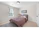 Inviting bedroom with soft carpeting, natural light from a window, and a plush bed, creating a comfortable retreat at 2283 Shady Maple Ln, Loganville, GA 30052