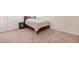 Clean bedroom with a comfortable bed, side table, and soft carpet at 2283 Shady Maple Ln, Loganville, GA 30052