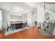 Elegant dining room with modern chandelier, tray ceiling, and hardwood floors at 2283 Shady Maple Ln, Loganville, GA 30052