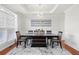 Bright dining room with a modern chandelier, tray ceiling, large window, and elegant decor at 2283 Shady Maple Ln, Loganville, GA 30052