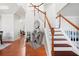 Bright foyer with wood floors, staircase, and elegant decor create a welcoming entrance at 2283 Shady Maple Ln, Loganville, GA 30052