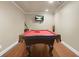 Spacious game room featuring a pool table, mounted television, and hardwood floors at 2283 Shady Maple Ln, Loganville, GA 30052
