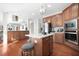 Open kitchen featuring an island, stainless appliances, and seamless living area access at 2283 Shady Maple Ln, Loganville, GA 30052