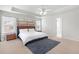 Bright main bedroom featuring a tray ceiling, ceiling fan, and two large windows for natural light at 2283 Shady Maple Ln, Loganville, GA 30052