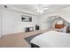 Spacious main bedroom with a tray ceiling, ceiling fan, tv, and a sitting area with a dresser at 2283 Shady Maple Ln, Loganville, GA 30052