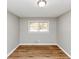 Empty bedroom with hardwood floors, neutral paint, and natural light from a double window at 4281 Welbron Dr, Decatur, GA 30035