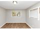 Cozy bedroom featuring hardwood floors, neutral paint, and two windows at 4281 Welbron Dr, Decatur, GA 30035