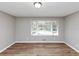 Cozy bedroom with laminate wood flooring, natural light, and neutral-toned walls at 4281 Welbron Dr, Decatur, GA 30035