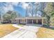 Quaint single-story home with an attached carport and an expansive driveway at 4281 Welbron Dr, Decatur, GA 30035