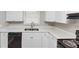Bright kitchen featuring white cabinets, quartz countertops and stainless steel sink under natural light at 4281 Welbron Dr, Decatur, GA 30035